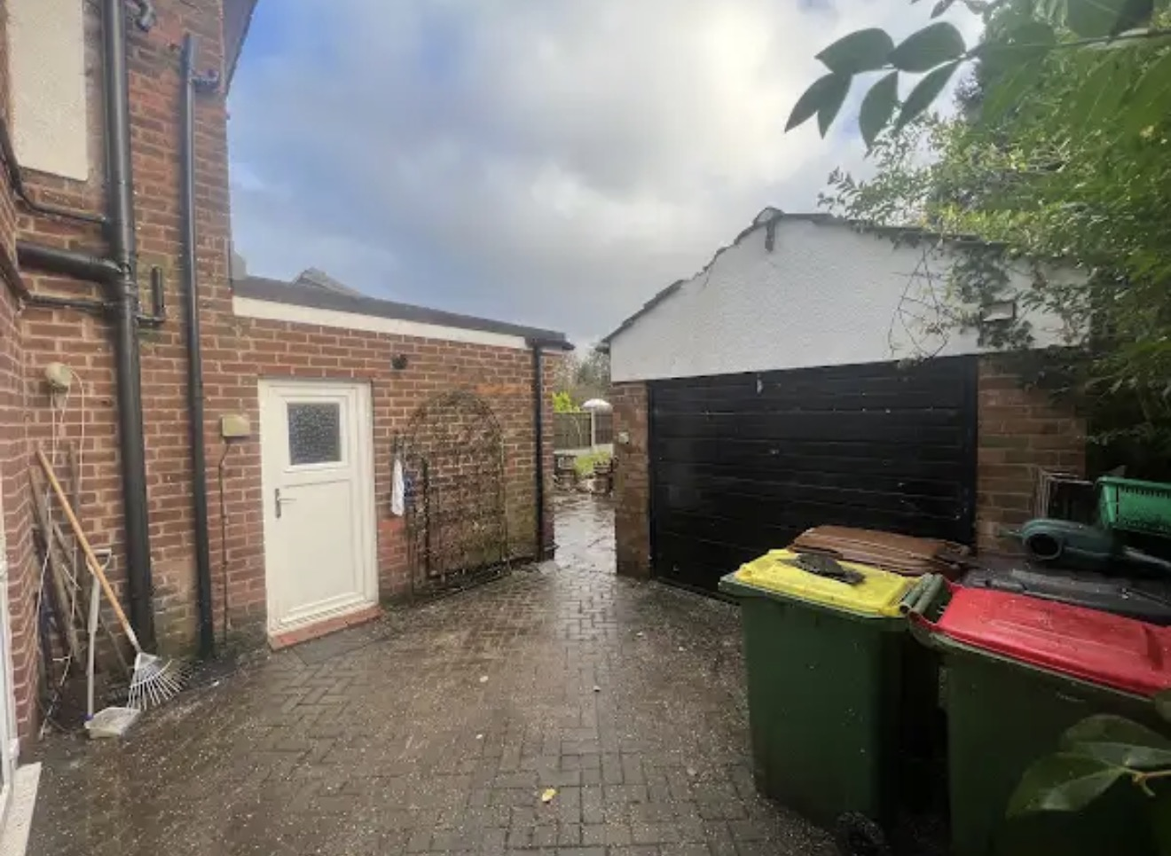 Access area between outbuildings cleared after the tree work